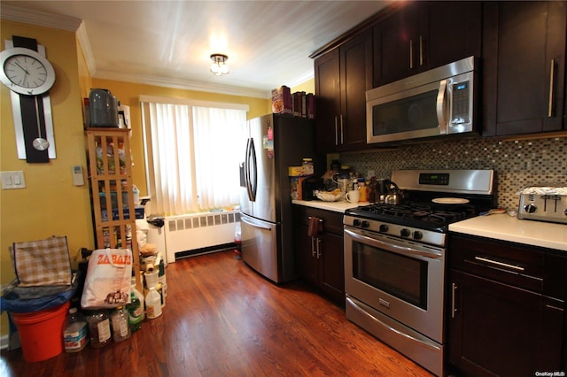 kitchen with backsplash, dark hardwood / wood-style flooring, radiator heating unit, and stainless steel appliances