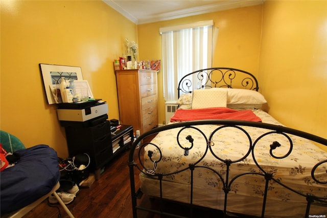 bedroom with dark hardwood / wood-style floors and crown molding