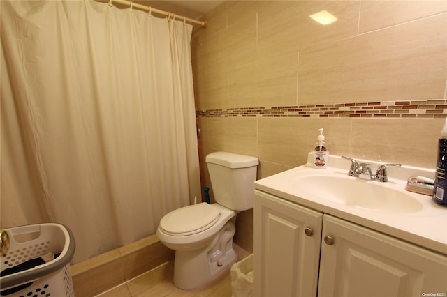 bathroom featuring curtained shower, vanity, and tile walls