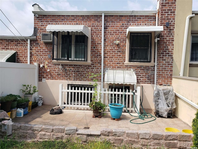 rear view of property featuring a wall mounted air conditioner