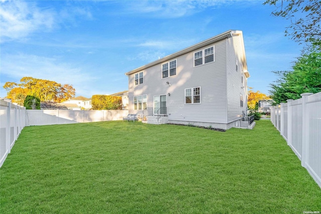 rear view of house with a yard