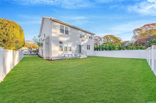 back of house featuring a lawn