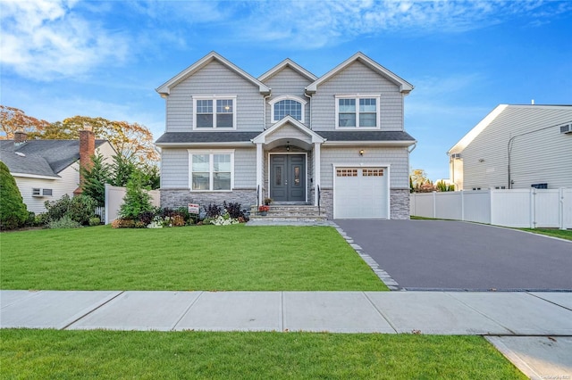 craftsman-style home featuring a garage and a front lawn