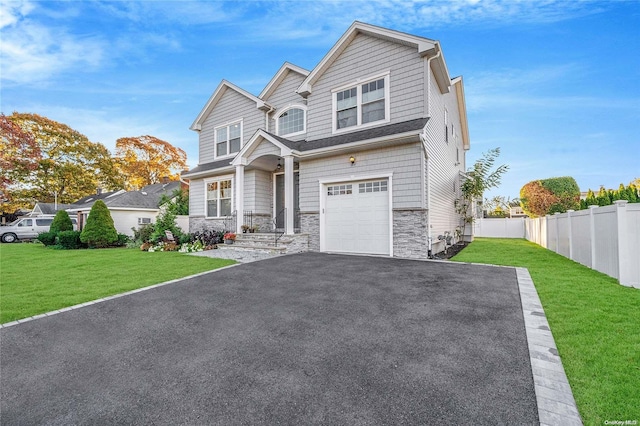 view of front of house with a garage and a front lawn