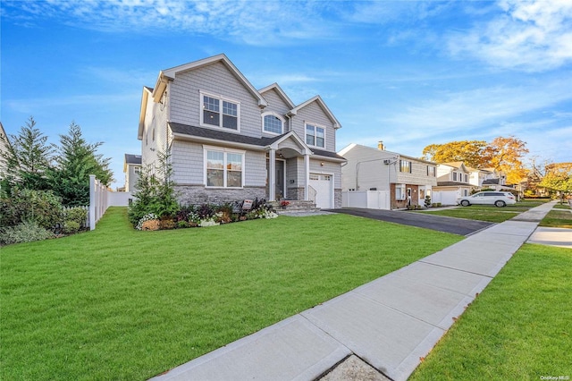 view of front of house featuring a front yard and a garage