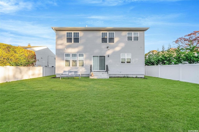 rear view of property with a lawn