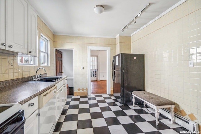 kitchen featuring white cabinetry, dishwasher, sink, black fridge, and ornamental molding