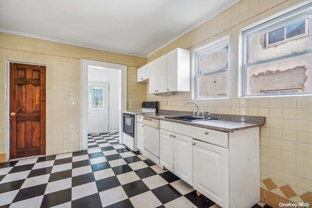 kitchen with sink, crown molding, white appliances, white cabinets, and tile walls