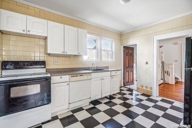 kitchen with ornamental molding, white appliances, sink, tile walls, and white cabinets