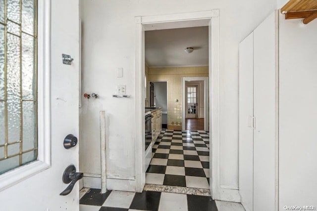 corridor featuring tile walls and a wealth of natural light