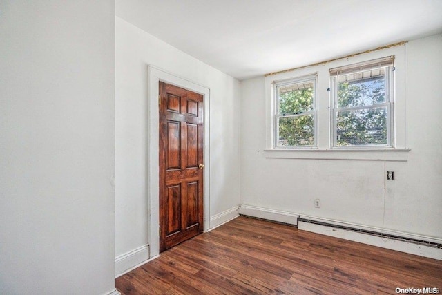 empty room with dark hardwood / wood-style flooring