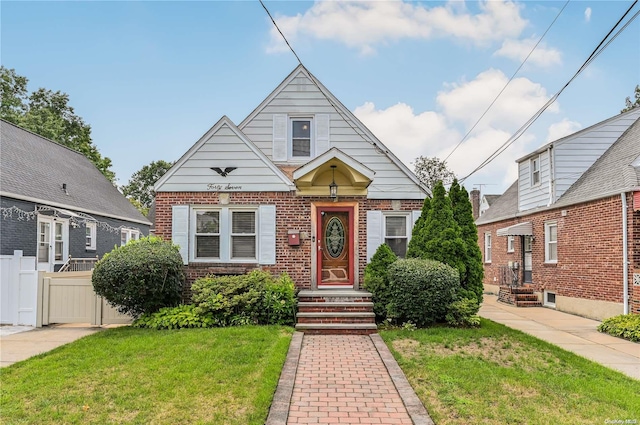 bungalow-style home featuring a front lawn