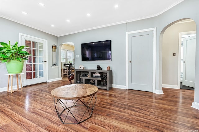 living room with crown molding and hardwood / wood-style floors