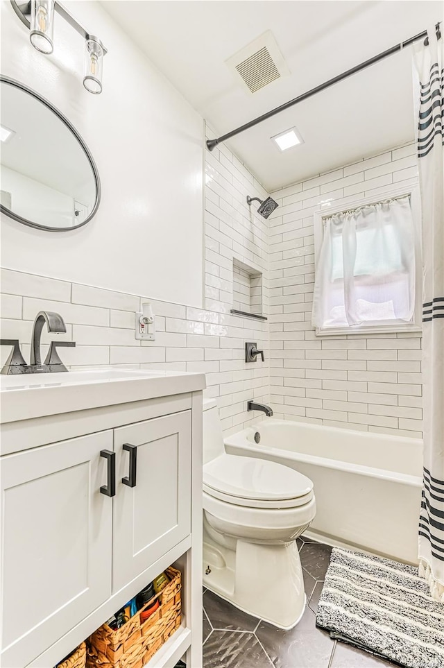 full bathroom with vanity, toilet, tile walls, and shower / tub combo with curtain