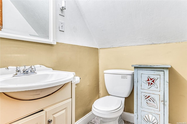 47 Alden Ave, Valley Stream, NY 11580 - bathroom featuring vanity, toilet, vaulted ceiling, and baseboards