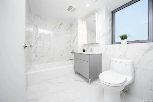 full bathroom with washtub / shower combination, vanity, toilet, and tile walls