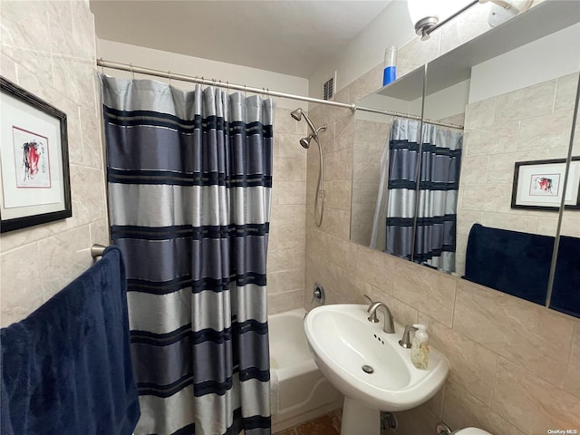 bathroom with tile walls and sink