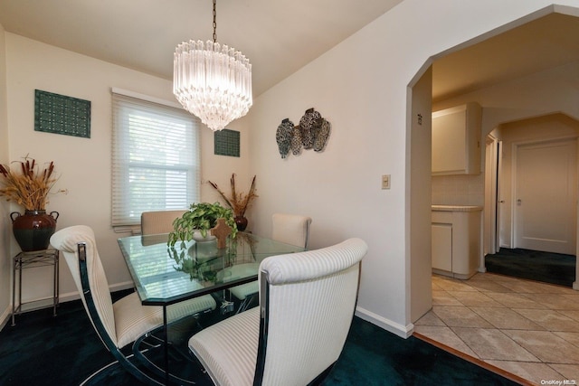 tiled dining area with an inviting chandelier