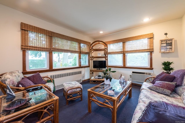 living room with an AC wall unit, radiator heating unit, and dark colored carpet