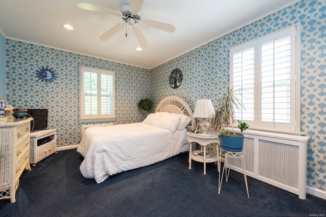 carpeted bedroom featuring radiator, ceiling fan, multiple windows, and ornamental molding