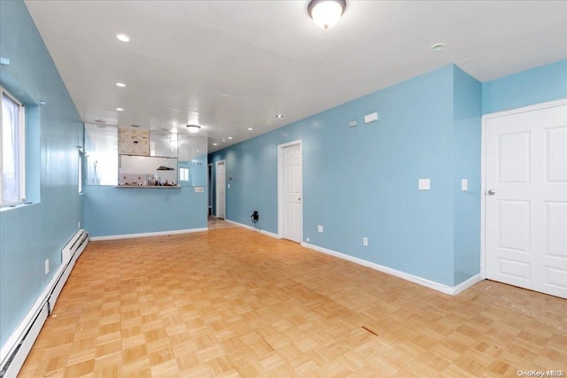 spare room with light parquet flooring and a baseboard heating unit