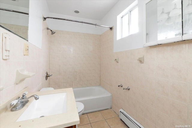 full bathroom with a baseboard heating unit, tile patterned floors, toilet, tile walls, and tiled shower / bath