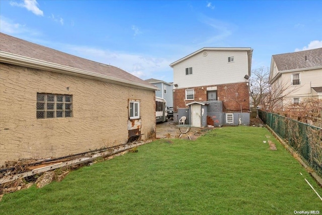 back of house with a lawn