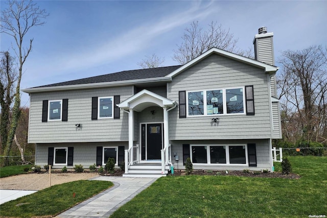 split foyer home featuring a front lawn