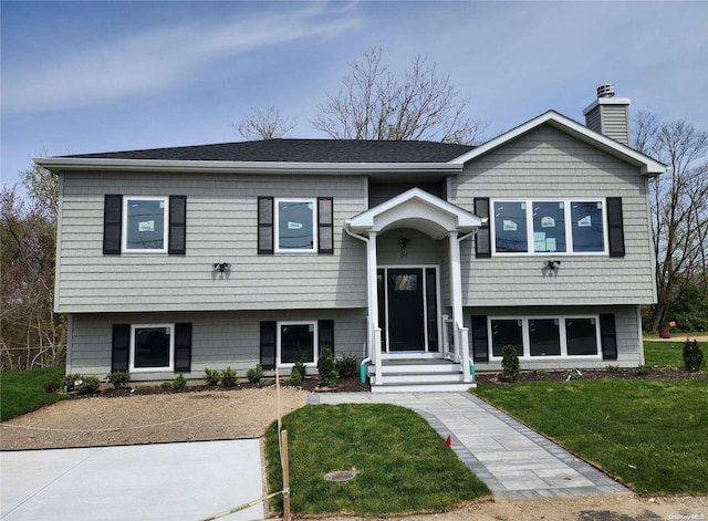 bi-level home with a front lawn