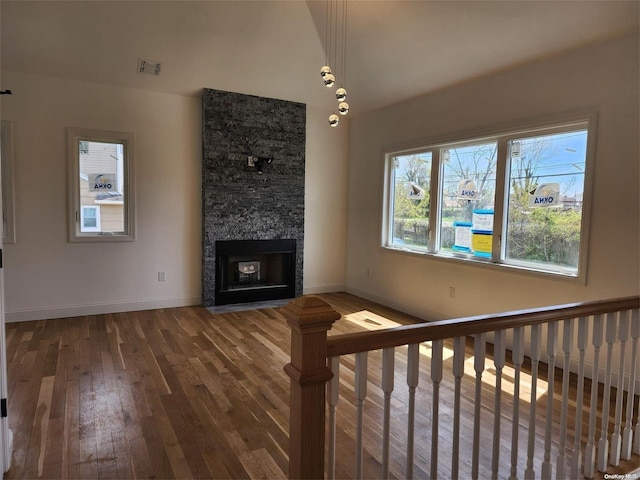 unfurnished living room with a fireplace and hardwood / wood-style flooring