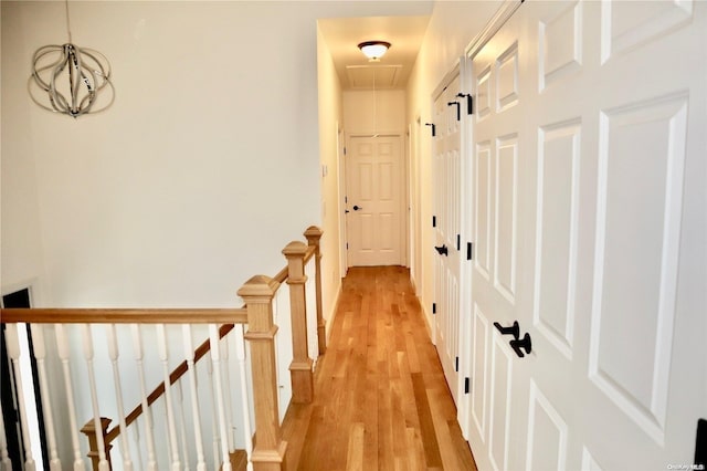 hallway with light hardwood / wood-style floors