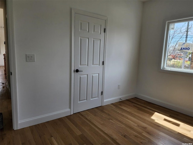 unfurnished room with hardwood / wood-style flooring