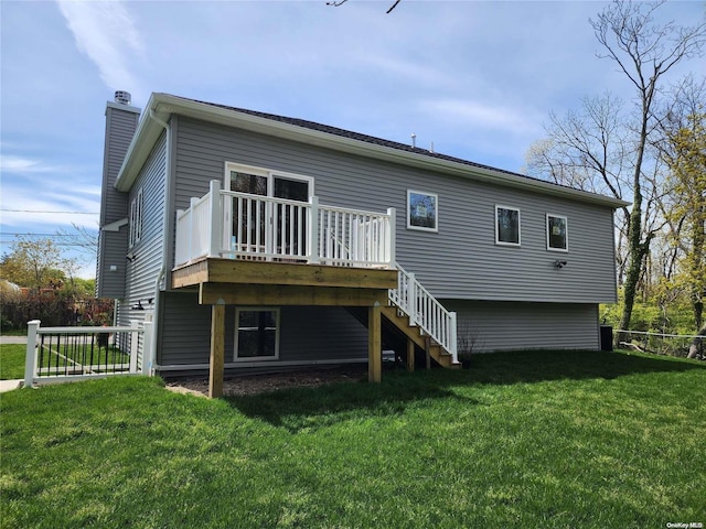 back of property with a wooden deck and a yard