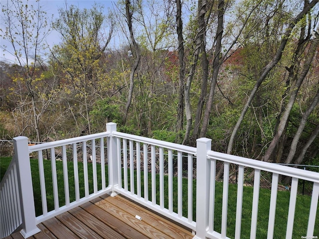 wooden deck with a lawn