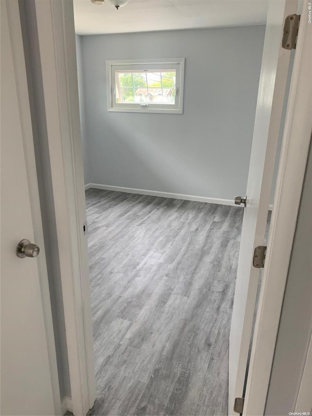 unfurnished room with light wood-type flooring