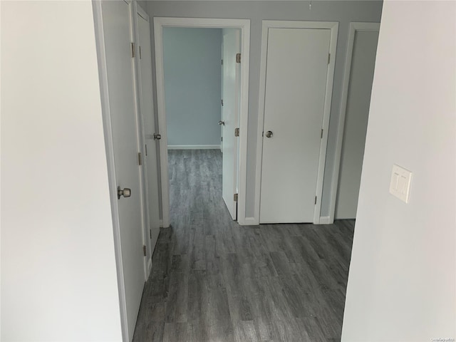 hallway with dark wood-type flooring