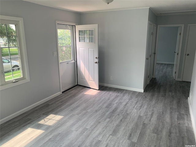 empty room featuring light wood-type flooring and crown molding