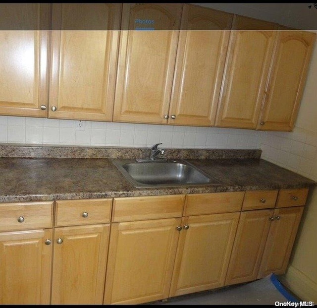 kitchen featuring decorative backsplash and sink