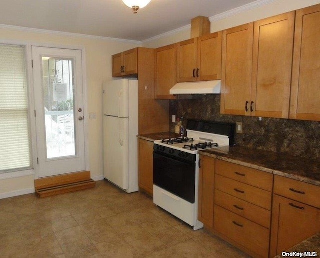 kitchen with decorative backsplash, white appliances, dark stone counters, and crown molding