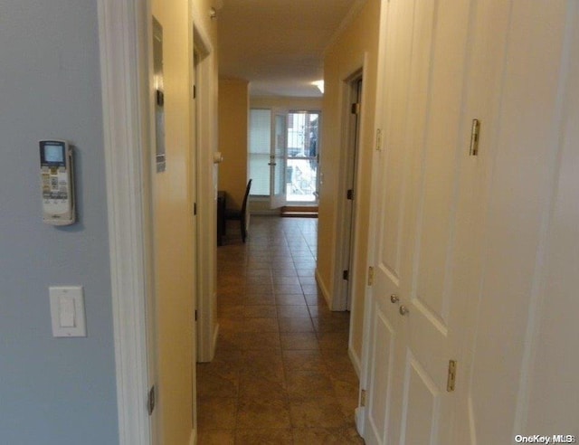 hall with dark tile patterned flooring