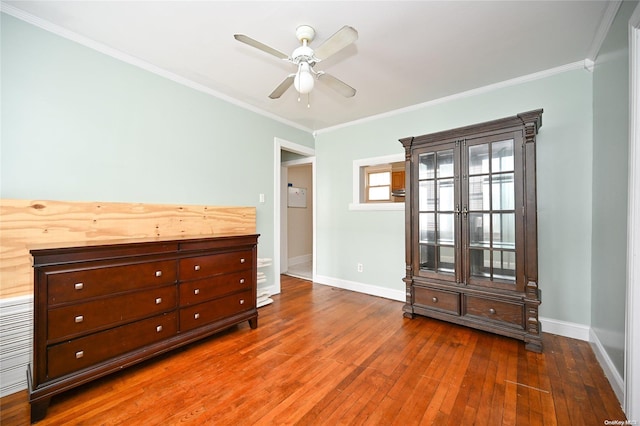 unfurnished room with ceiling fan, dark hardwood / wood-style flooring, and ornamental molding