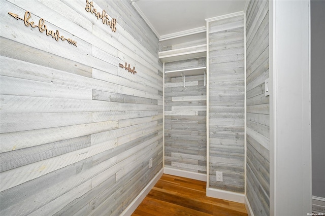 interior space with hardwood / wood-style floors and wood walls