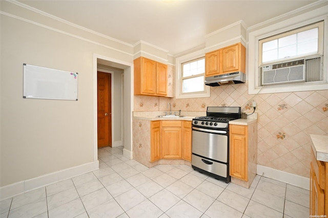 kitchen with gas stove, crown molding, light tile patterned floors, and sink