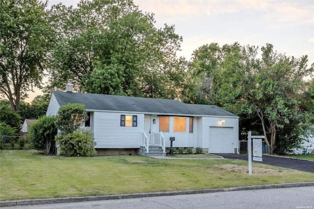 view of front of house featuring a yard and a garage