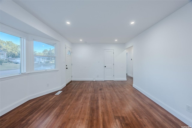 spare room with dark hardwood / wood-style flooring