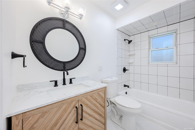 full bathroom with tiled shower / bath, vanity, and toilet