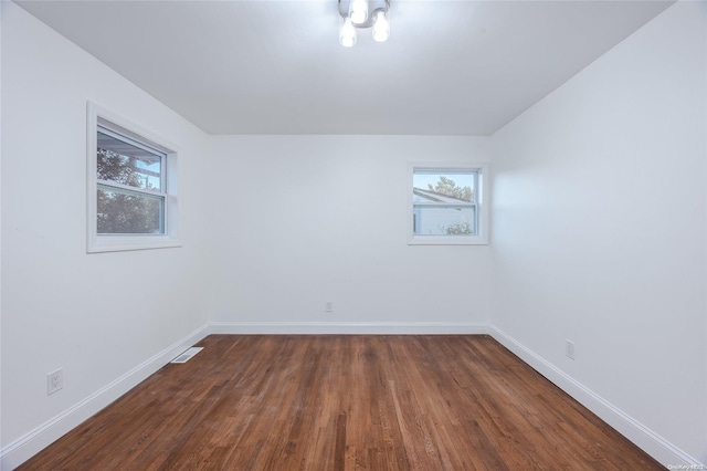 empty room featuring dark hardwood / wood-style flooring