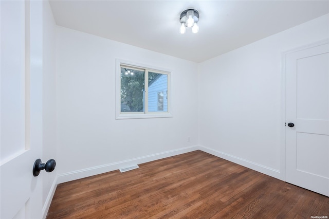 spare room featuring dark hardwood / wood-style flooring