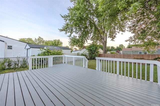 wooden terrace featuring a yard