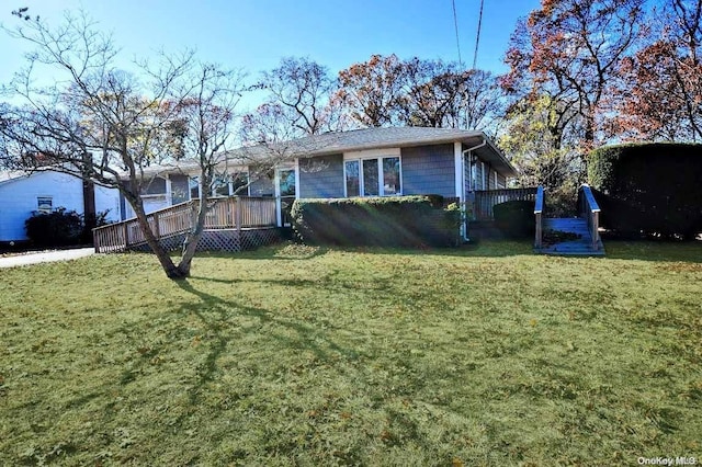 view of front facade with a deck and a front lawn